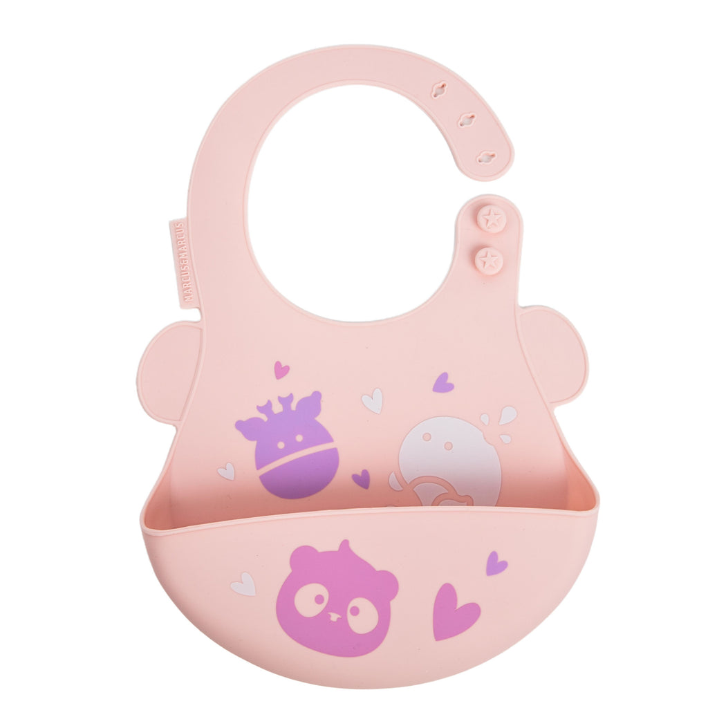 Marcus & Marcus pastel pink silicone baby bib with a wide mouth bowl, featuring cute purple and white cartoon animal prints and small heart details, shown on a solid white background.