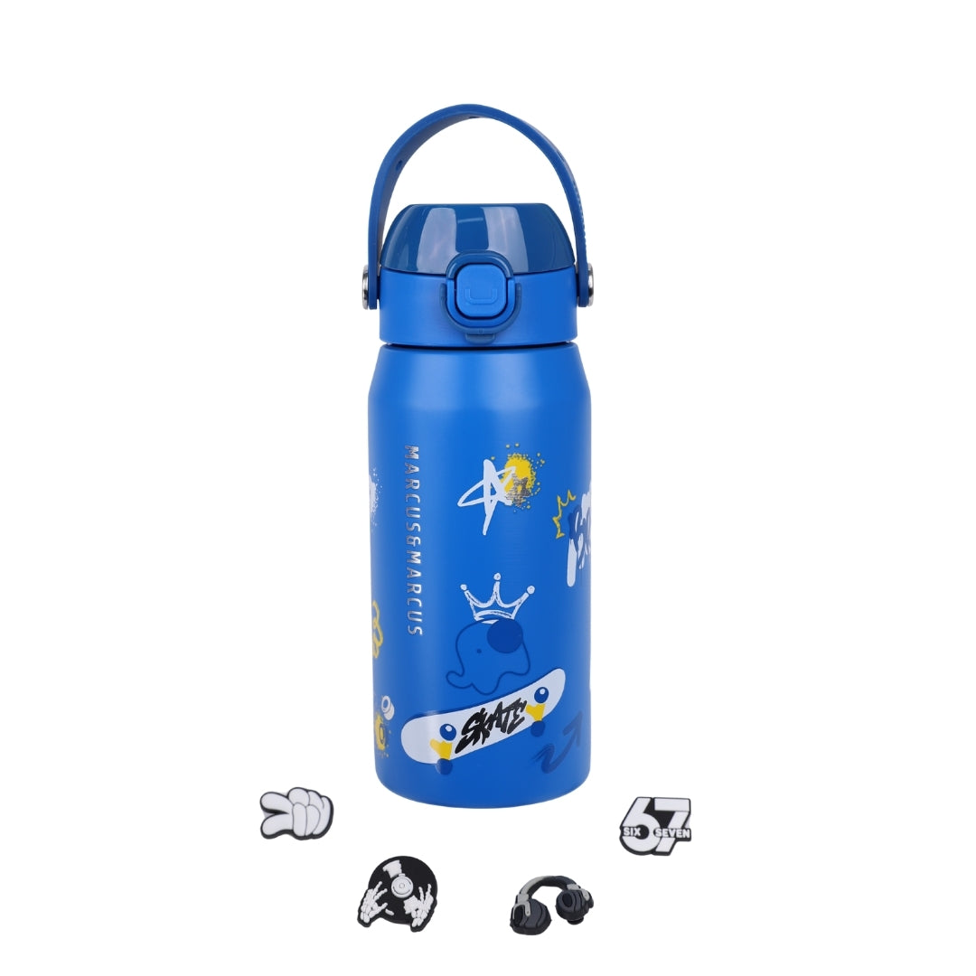 A blue insulated water bottle with a matching blue carry handle lid, decorated with cartoon graphics including a skateboard, stars, and a crown. Four small accessory charms are arranged below the bottle on a plain white background.