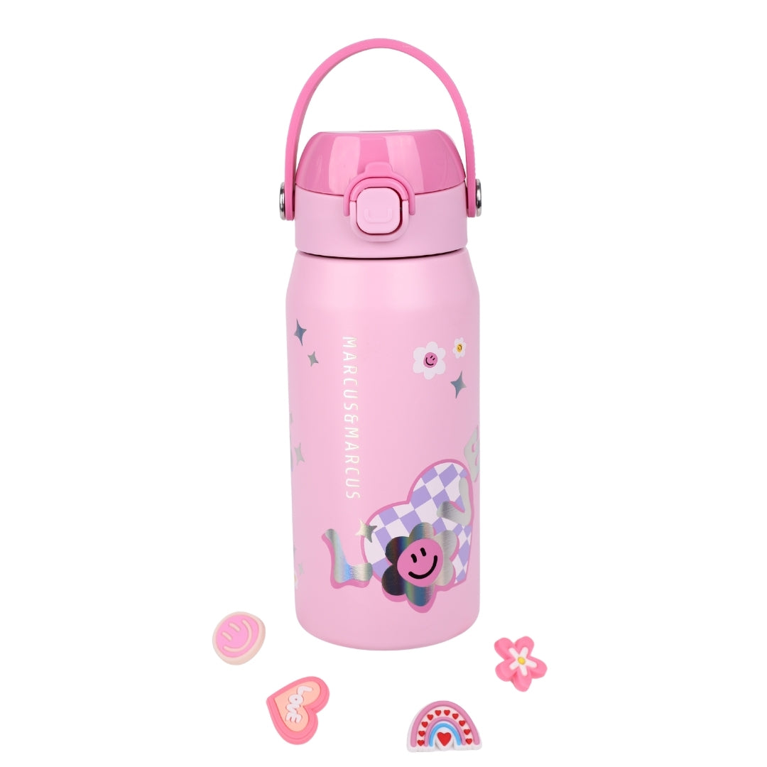 A pink insulated water bottle with a matching pink lid and carry loop, decorated with pastel graphics including a smiling flower, stars, and small accessory charms placed in front on a white background.